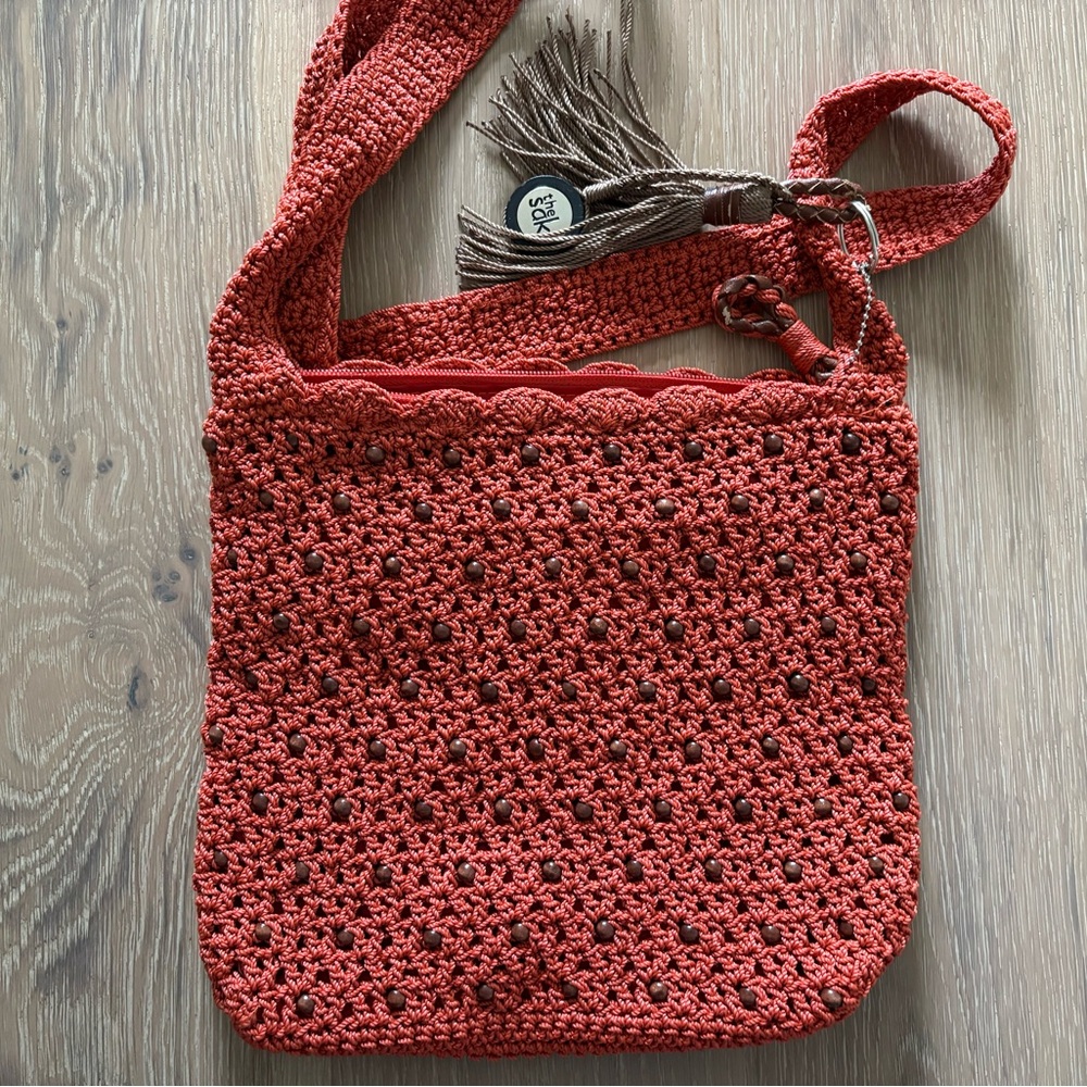 The Sak Amber/Rust Red Crochet Shoulder Bag with Wooden Beads